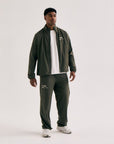 Model wearing Cuera Active Cuera Track Jacket in Army, front studio view