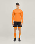 Model wearing Cuera Oncourt LS Layer T-Shirt in Orange, front studio view