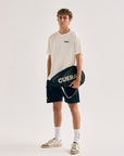 Model wearing Cuera Padel Racket Sleeve in Black, front studio view