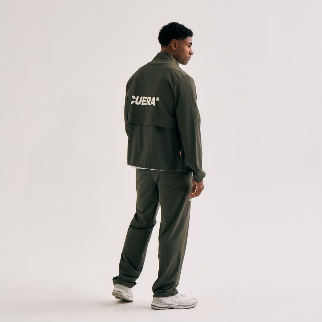 Model wearing Cuera Active Cuera Track Pants in Army, front studio view