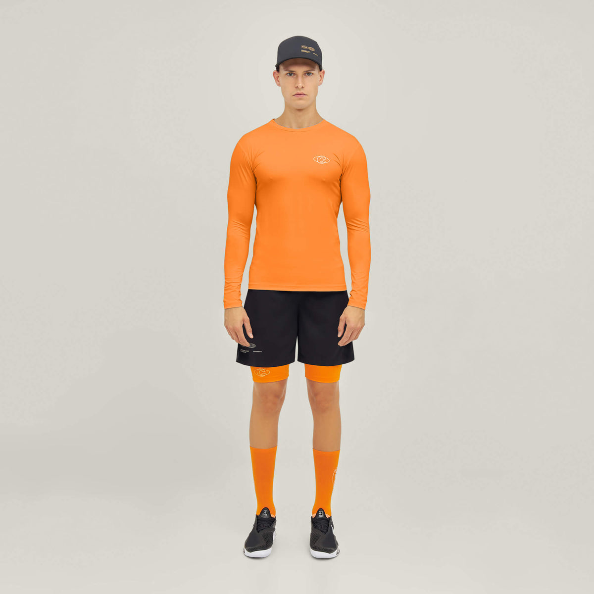 Model wearing Cuera Oncourt LS Layer T-Shirt in Orange, front studio view